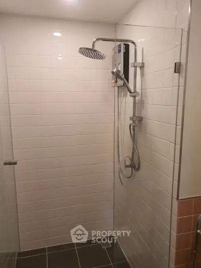 Modern bathroom with glass shower enclosure and sleek fixtures