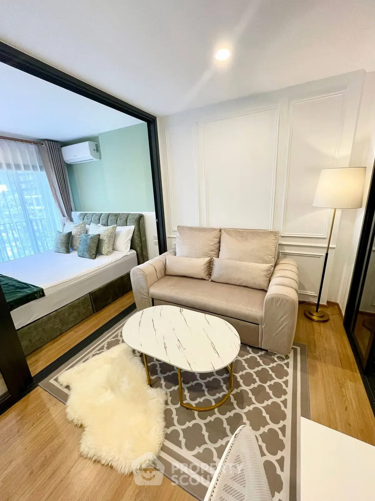 Chic modern living room with cozy seating and stylish decor in a contemporary apartment.