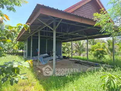 Charming rustic outdoor structure surrounded by lush greenery, perfect for relaxation and nature lovers.