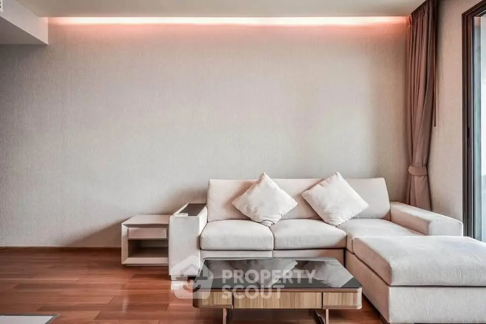 Modern living room with stylish sofa and elegant lighting, perfect for relaxation and entertaining.