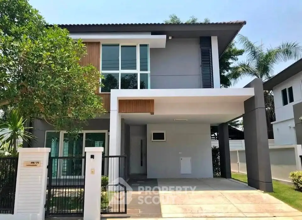 Modern two-story house with sleek design and spacious driveway in a serene neighborhood.