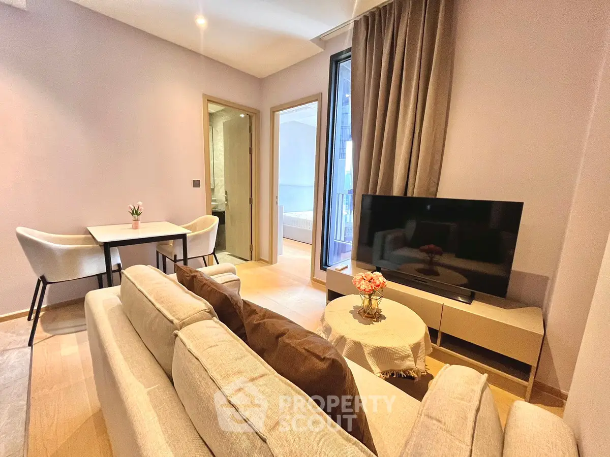 Modern living room with cozy seating and large TV, perfect for relaxation.