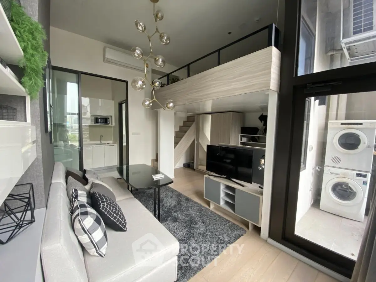 Modern loft apartment with mezzanine, stylish living area, and large windows for natural light.