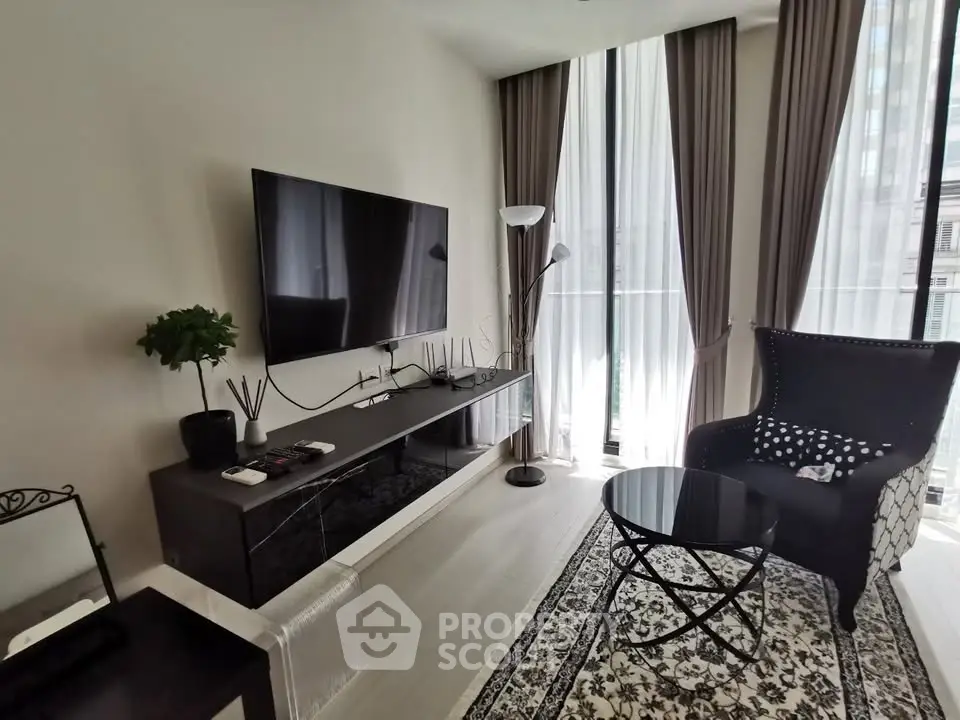 Modern living room with sleek furniture and large windows offering natural light.