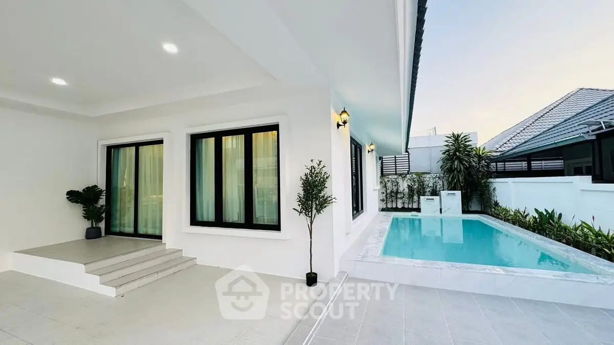 Modern home exterior with private pool and elegant lighting