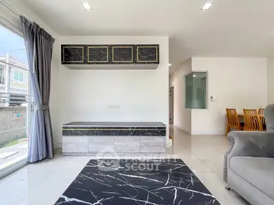 Modern living room with marble accents and elegant dining area