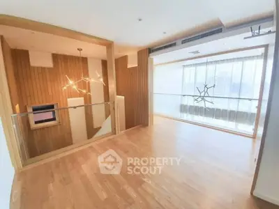 Spacious modern living room with wooden flooring and stylish lighting