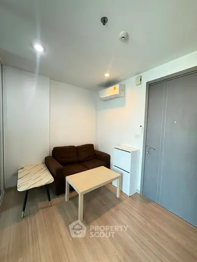 Cozy living room with modern furniture and air conditioning in a stylish apartment.