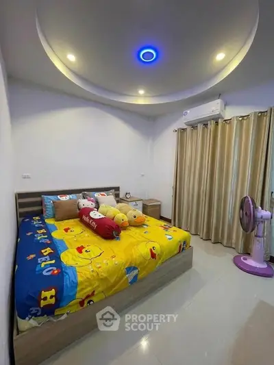 Charming bedroom with playful decor and modern lighting, perfect for a cozy and inviting atmosphere.