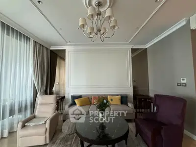 Elegant living room with plush seating and chandelier in modern apartment