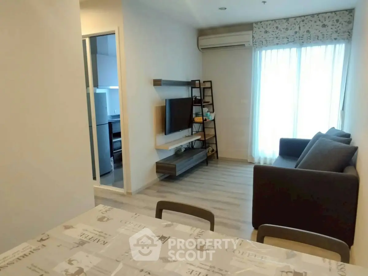 Modern living room with stylish furniture and natural light, perfect for cozy living.