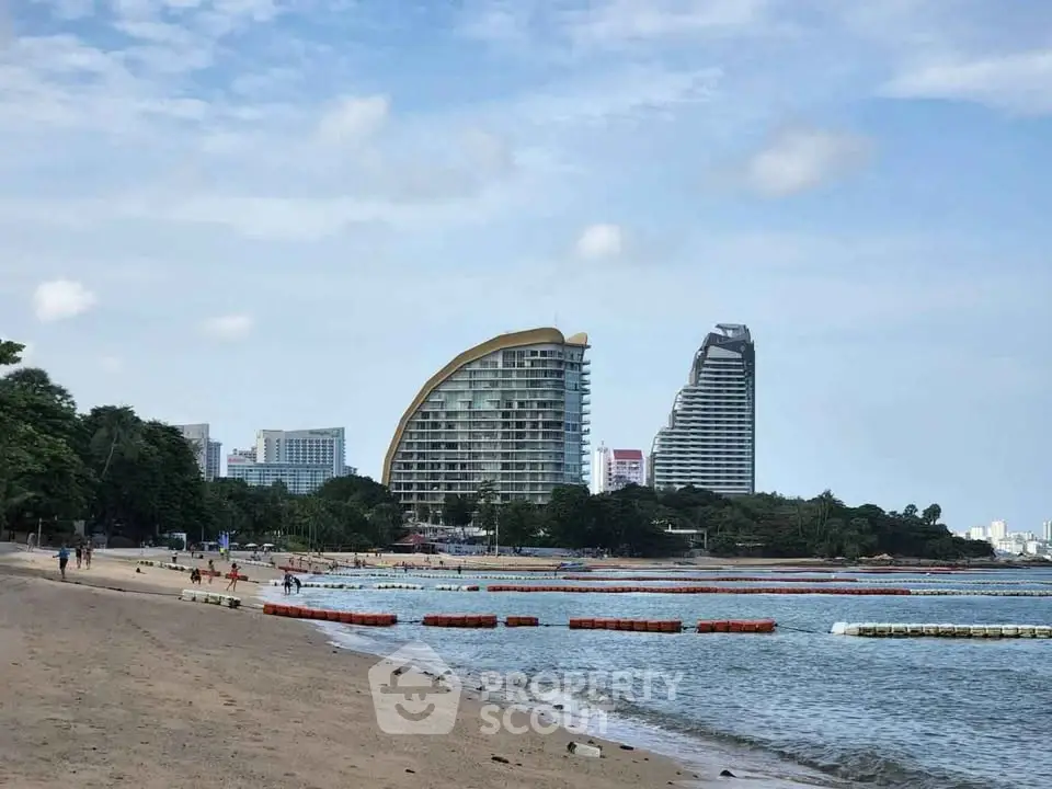 Stunning beachfront view with modern high-rise buildings and serene coastline.