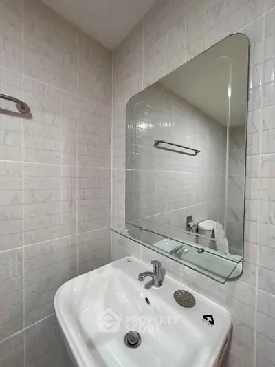 Compact bathroom with modern sink and mirror, ideal for small spaces.