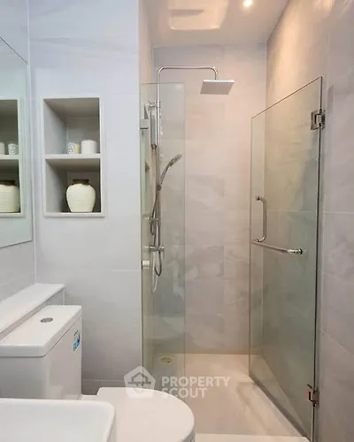 Modern bathroom with glass shower and sleek fixtures