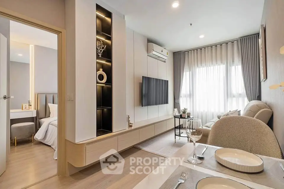 Modern living room with elegant decor and natural light, featuring a cozy seating area and stylish dining setup.