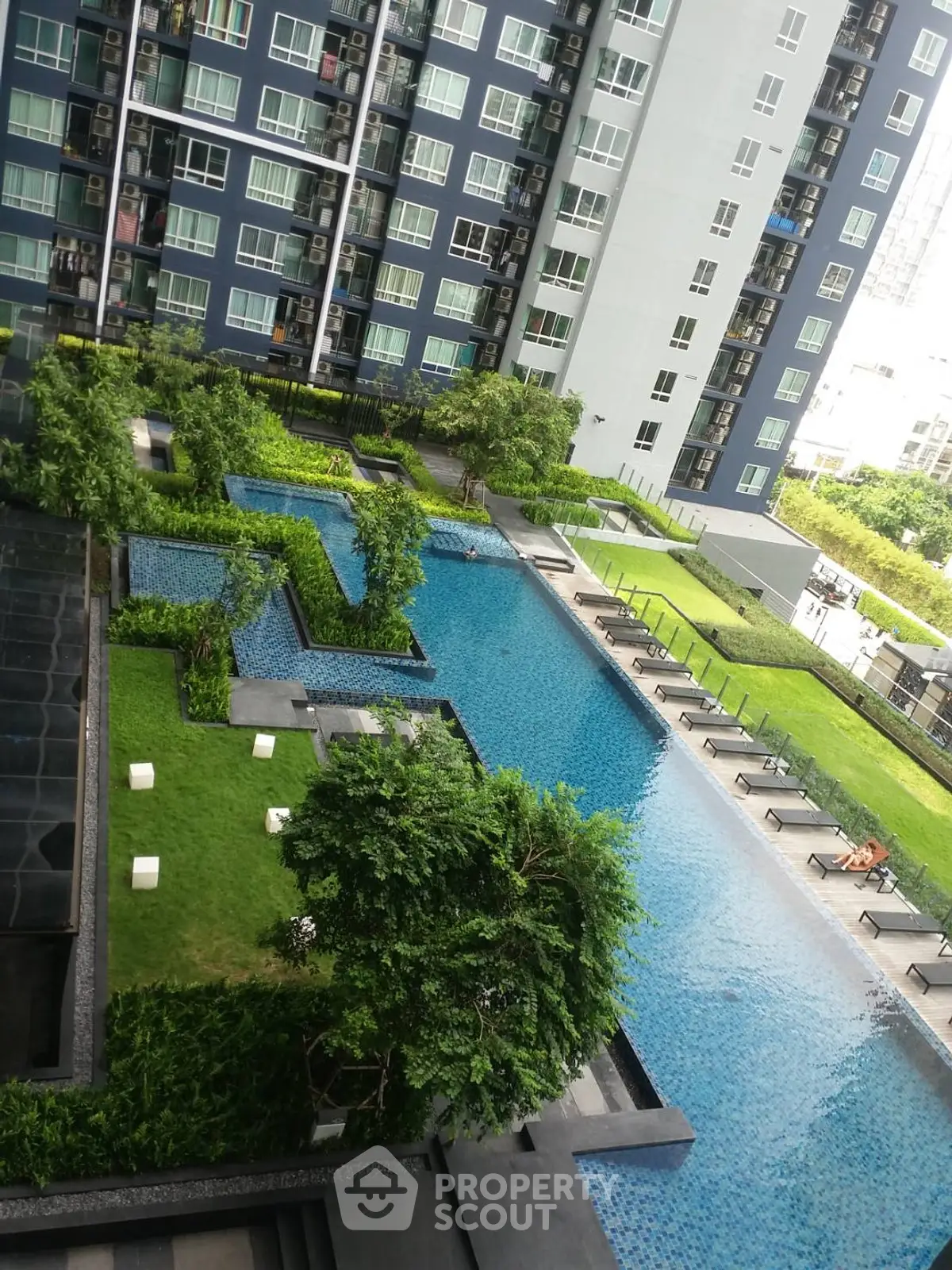 Luxurious condominium with stunning pool and lush garden view