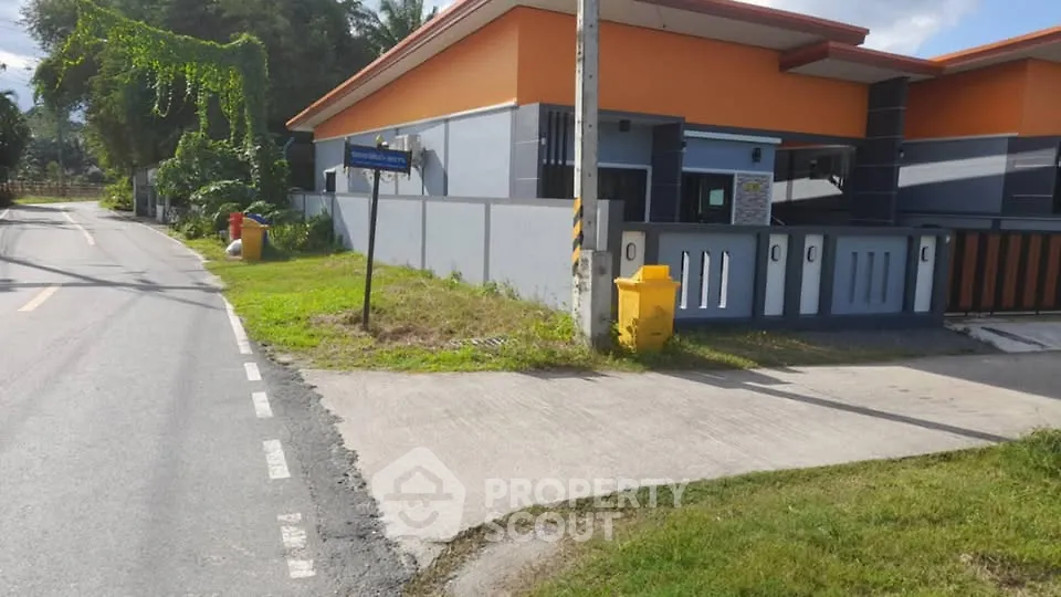 Modern residential building with vibrant orange accents and a well-maintained exterior.