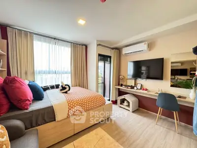 Modern bedroom with stylish decor, large window, and balcony access in a cozy apartment.