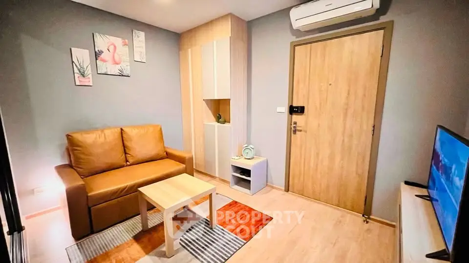 Modern living room with cozy sofa, stylish decor, and air conditioning in a contemporary apartment.