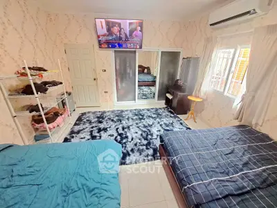 Spacious bedroom with modern decor, mirrored wardrobe, and air conditioning, perfect for comfort and relaxation.