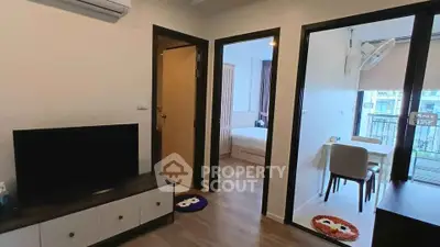 Modern apartment interior with living room, bedroom, and balcony view.
