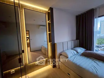 Modern bedroom with stylish lighting and city view, featuring a cozy bed and sleek wardrobe.