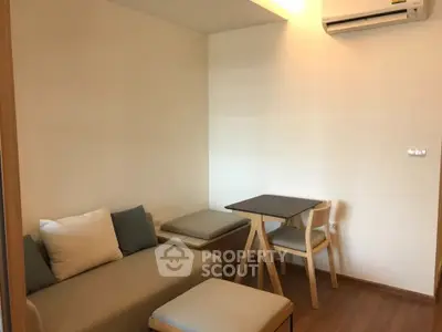 Cozy living room with modern furniture and air conditioning, perfect for relaxation.