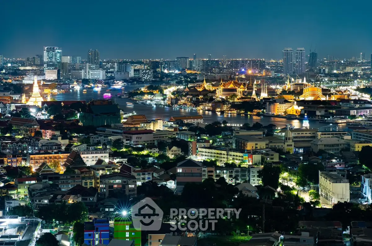 Stunning nighttime cityscape with illuminated buildings and river view.