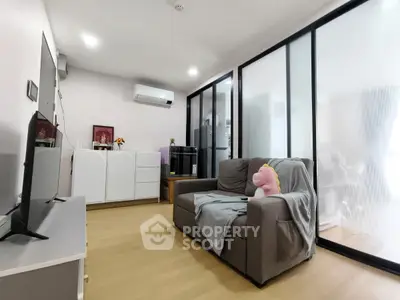Modern living room with cozy sofa and sleek glass partitions