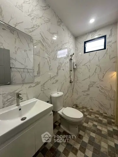 Modern bathroom with marble tiles and sleek fixtures