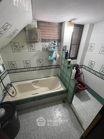 Charming bathroom with vintage tiles and bathtub, perfect for a cozy home retreat.