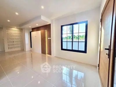Spacious modern living room with large window and sleek tile flooring