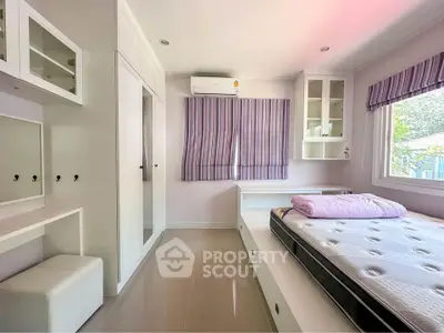 Modern bedroom with built-in storage and large window