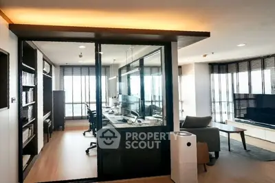 Modern living room with glass-enclosed study area and sleek furnishings