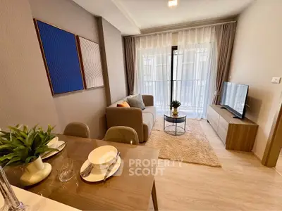 Modern living room with cozy sofa, stylish decor, and large window for natural light.