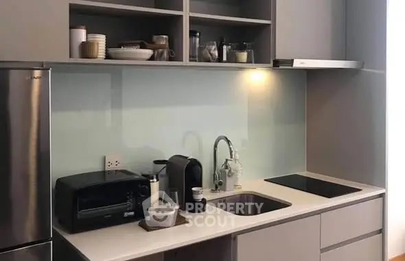 Modern kitchen with sleek cabinetry and appliances, featuring a minimalist design.