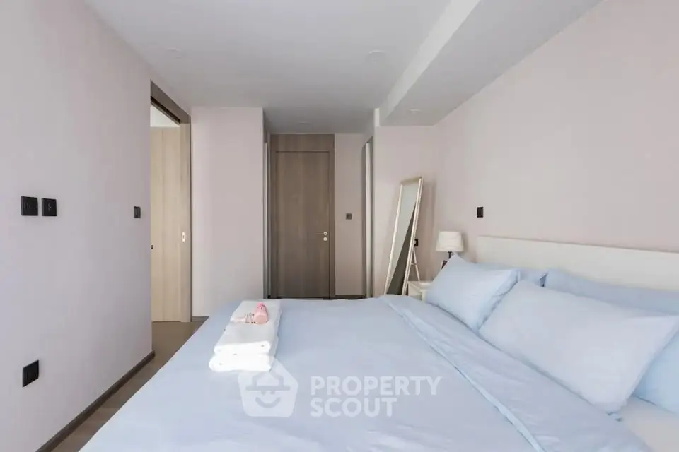 Spacious modern bedroom with minimalist design and soft lighting