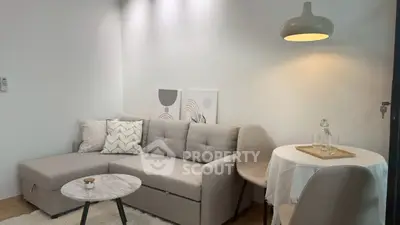 Modern living room with stylish gray sofa and elegant lighting