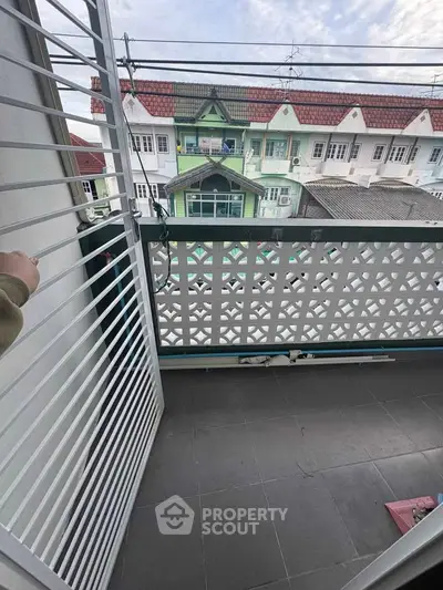 Charming balcony with decorative railing and urban view, perfect for relaxation and enjoying city life.