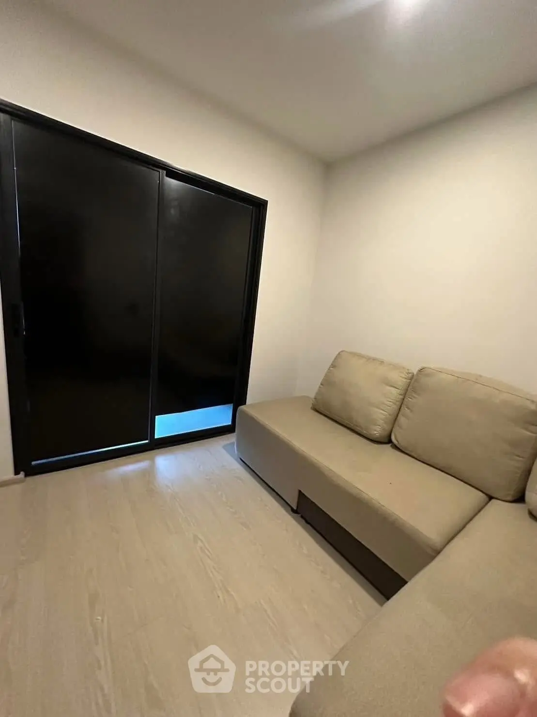 Cozy small living room with modern sofa and sliding glass door