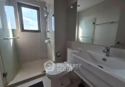 Modern bathroom with glass shower and sleek fixtures