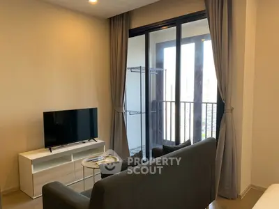 Modern living room with balcony view, sleek furniture, and natural light.