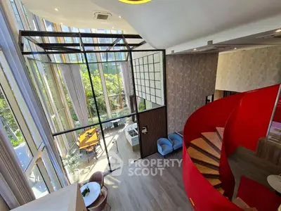 Stunning modern living room with high ceilings and spiral staircase