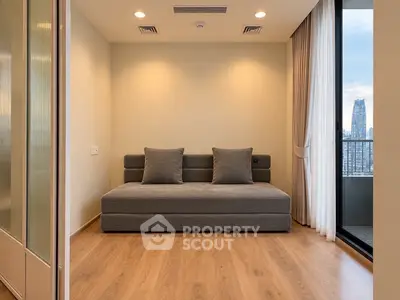 Modern living room with stylish sofa and city view from balcony, featuring elegant wooden flooring.