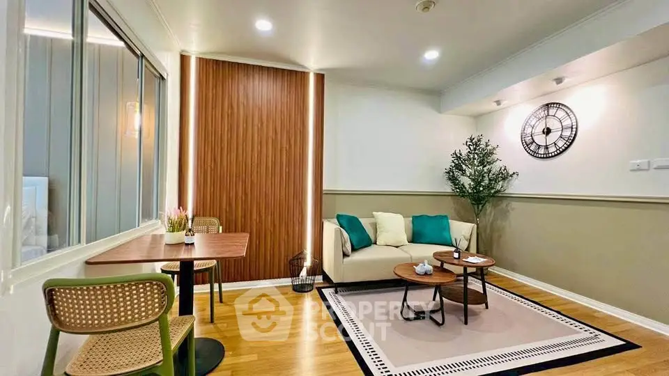 Stylish living room with modern decor, wooden flooring, and cozy seating area.