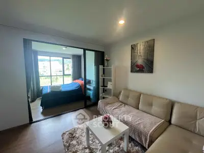 Modern living room with cozy sofa and view into stylish bedroom