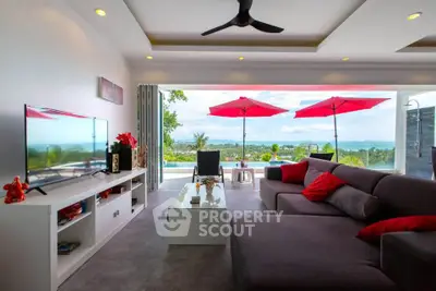 Luxurious living room with stunning ocean view and modern decor, perfect for relaxation and entertainment.