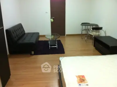 Modern studio apartment with sleek furniture and wooden flooring