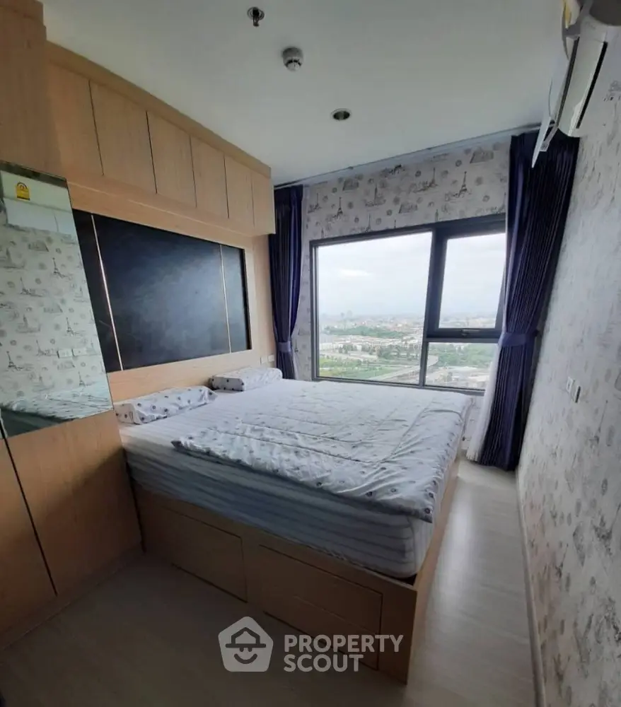 Modern bedroom with large window offering stunning city view