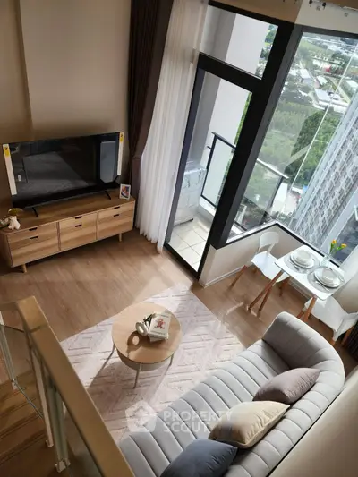 Modern living room with high ceiling and large window offering stunning city view, featuring stylish furniture and decor.